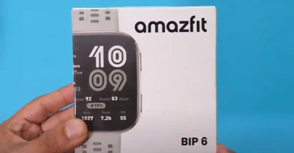 I Wore the Amazfit Bip 6 for 7 Days – Here’s What I Found 2 Unboxing Amazfit Bip 6 smartwatch showing retail box, watch, charger, and user manual on table
