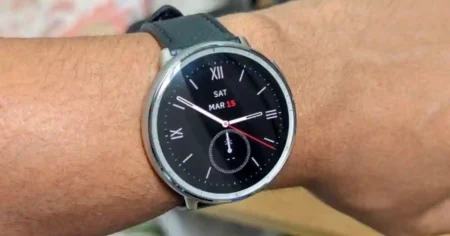 Close-up of Amazfit Active 2 smartwatch showing updated interface after firmware version 6.1.20.2, featuring double-tap to wake and improved display options