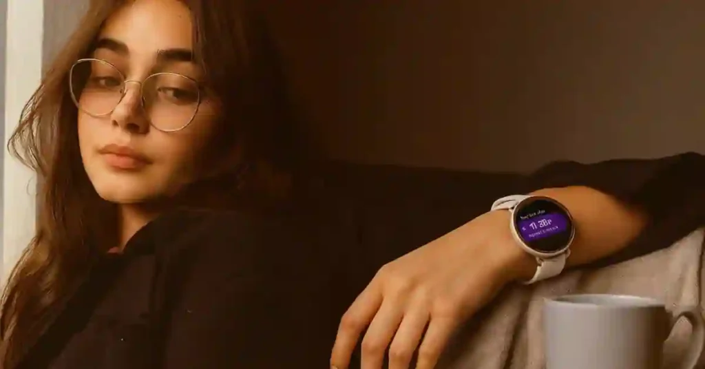 Female smartwatch reviewer wearing a slim watch while testing multiple fitness smartwatches at a clean workspace